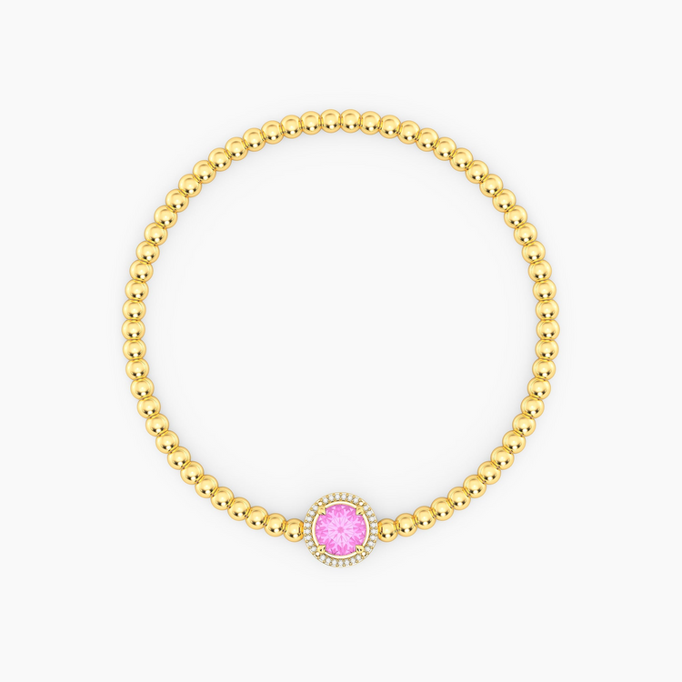 Gold plated beaded bracelet with a round pink center stone and diamond halo.