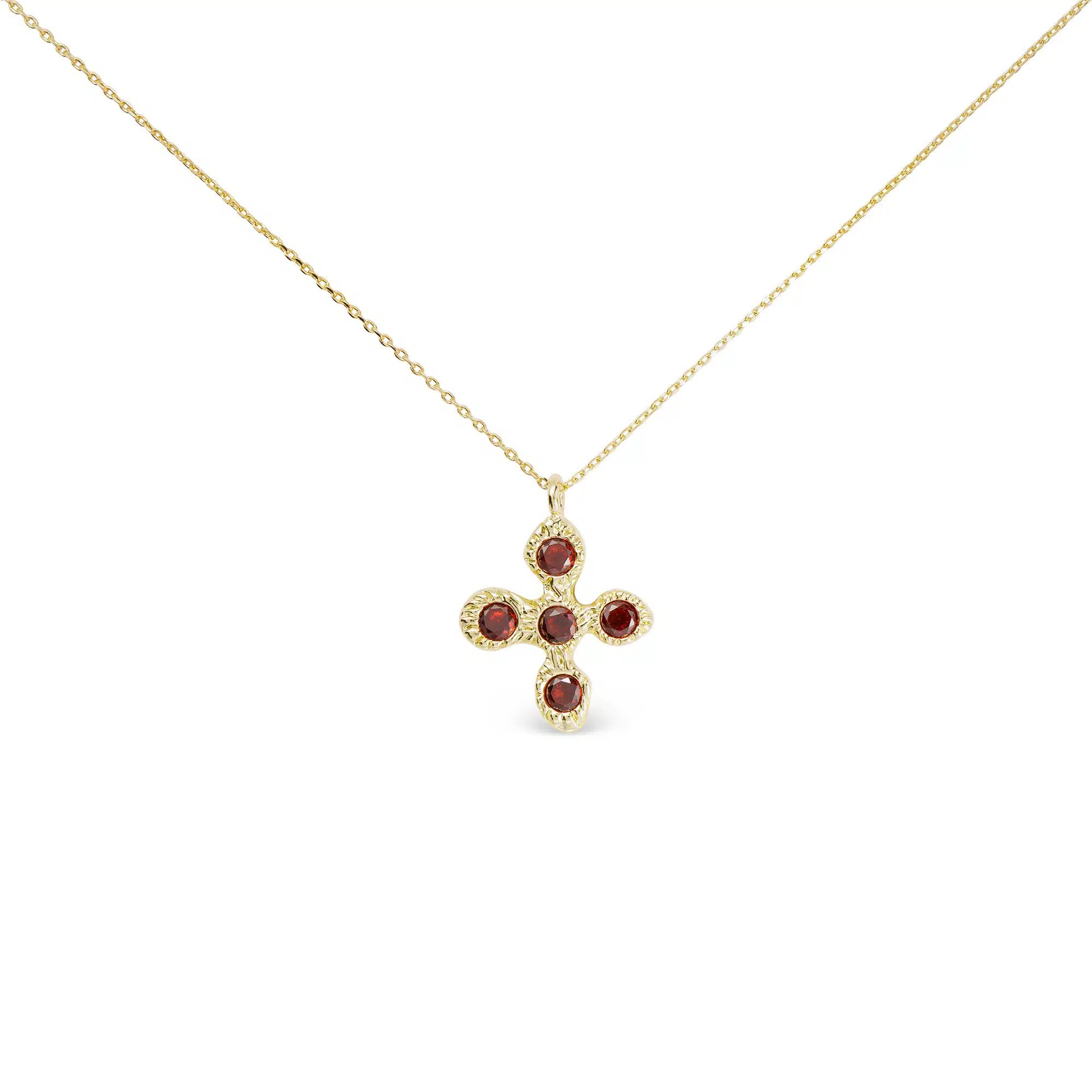 Gold cross necklace featuring five round red CZ stones on a delicate gold chain.