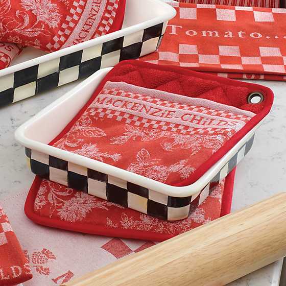 8-inch Courtly Check enamel baking pan with black and white checkered pattern on a red pot holder.