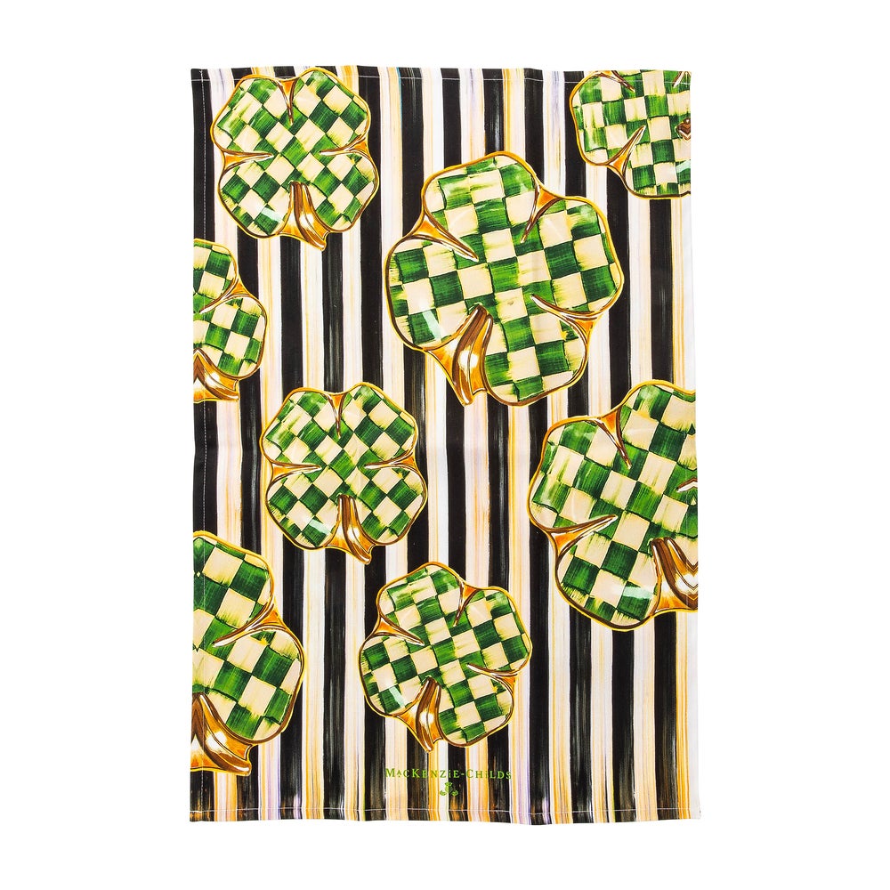 Dancing Clovers Dish Towel with green checkered shamrocks on a black and white striped background.