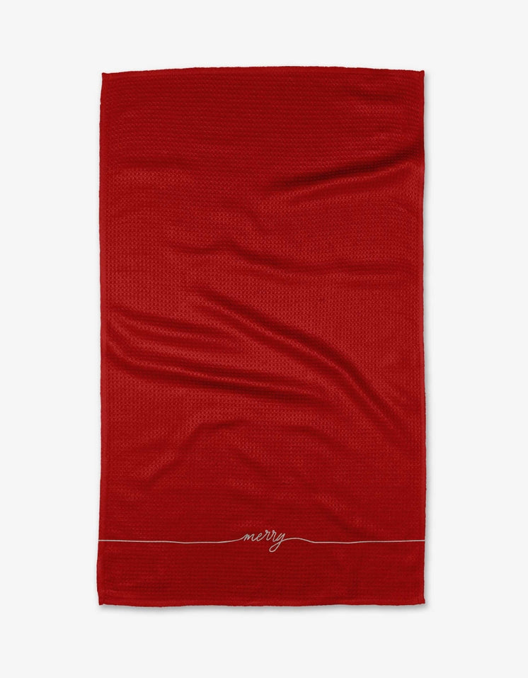 Holiday tea towel with waffle weave construction in red featuring a festive snowflake pattern.