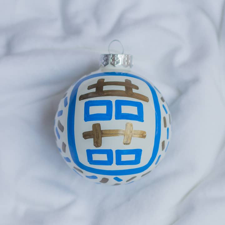 Hand-painted ceramic ornament featuring a red double happiness symbol on a white spherical silhouette.