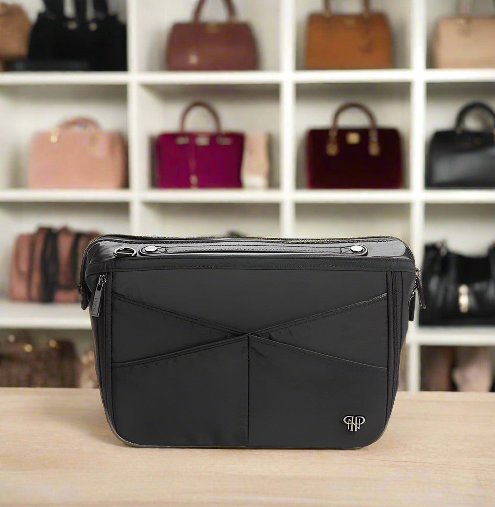 Black Littbag handbag organizer with multiple pockets and top handle on a wooden surface.