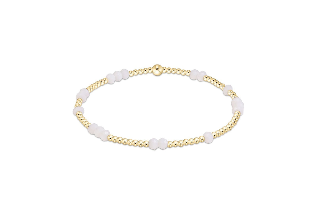 Gameday Flirty Hope Unwritten Bracelet with gold beads and pale pink faceted stones.