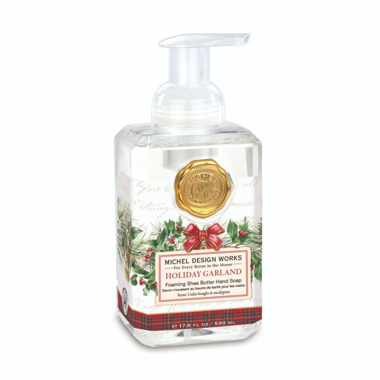 Foaming hand soap dispenser with a holiday garland-themed label.