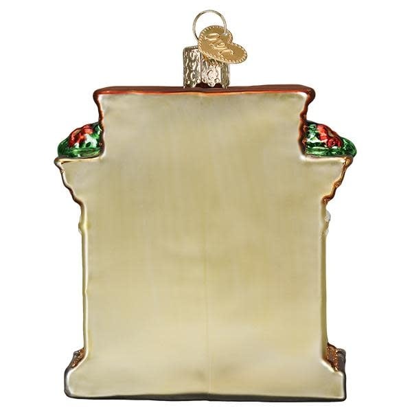 Back view of a Holiday Hearth ornament featuring a fireplace scene with stockings.