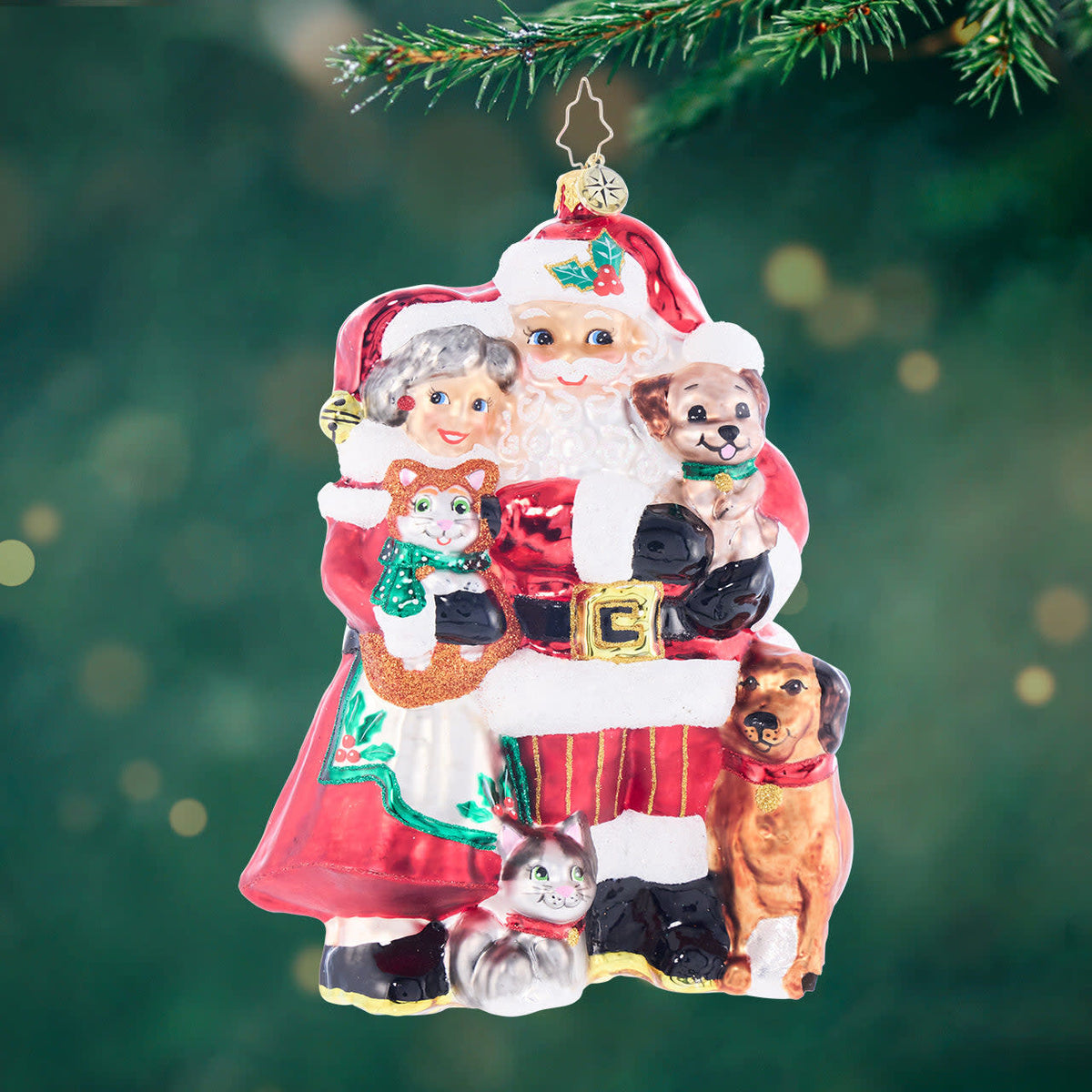 Holiday Paws plush toy shaped like a paw print with Santa Claus and Mrs. Claus figures on top.