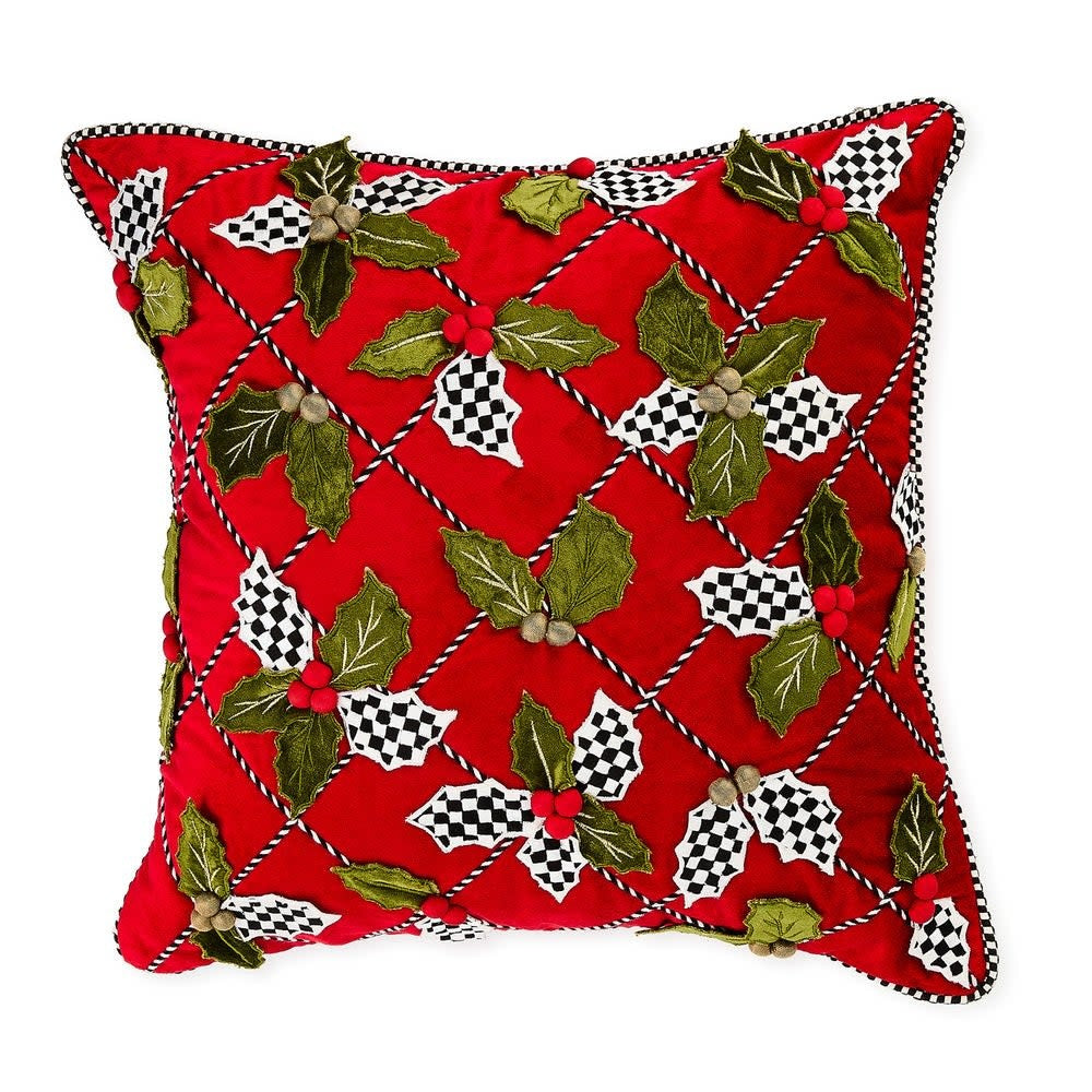 Square holly lattice throw pillow with black and white striped festive pattern on a soft fabric surface.