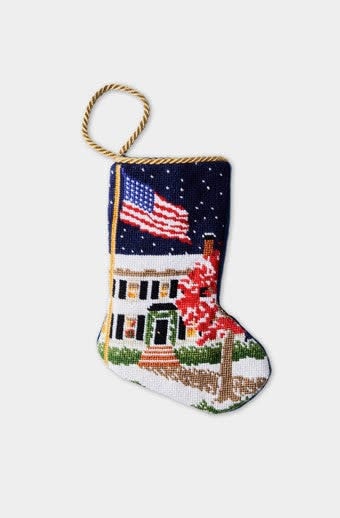 Hand-stitched needlepoint holiday stocking with velvet backing in red featuring gold bauble pattern