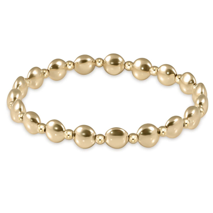 Gold Honesty bead bracelet with a grateful geometric pattern on elastic cord
