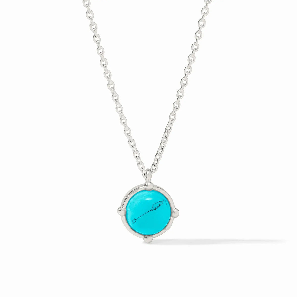 Silver cable chain necklace with a faceted turquoise blue gemstone pendant enhanced by four dangling beads.