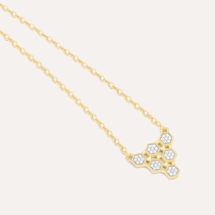 Honeycomb pendant necklace with diamond accents on a gold-plated sterling silver chain.