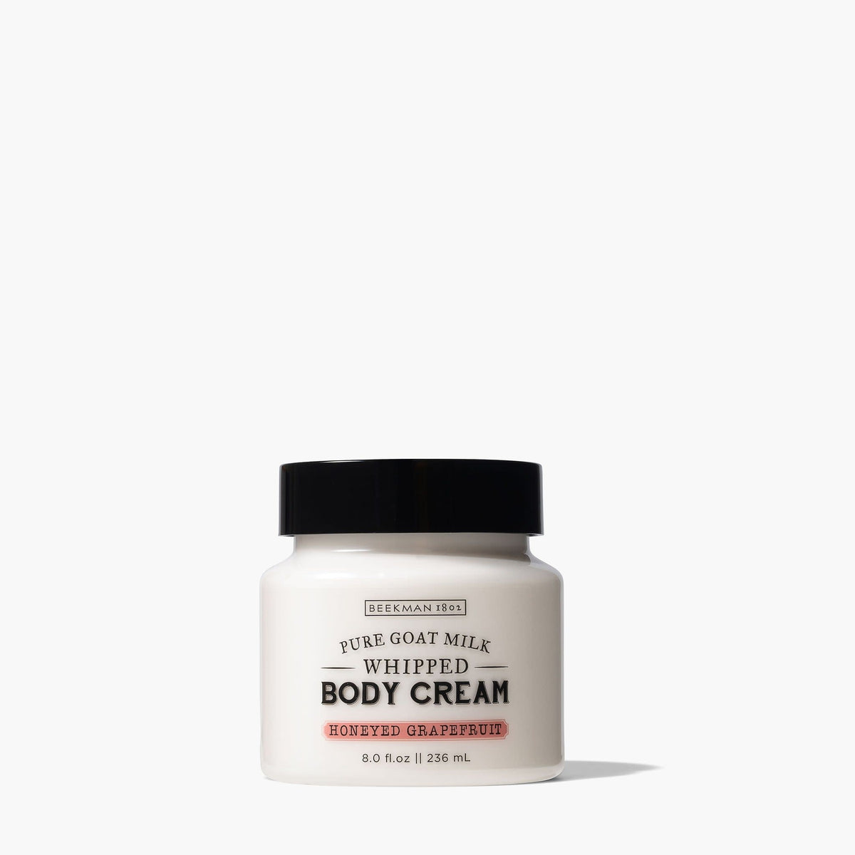 White tub of honeyed grapefruit whipped body cream with a silver lid.