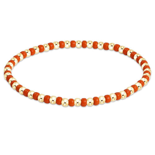 Hope Grateful bracelet featuring bright orange seed beads with gold-filled accents on elastic cord.