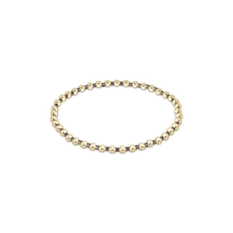 Taupe seed bead bracelet with gold accents on elastic cord