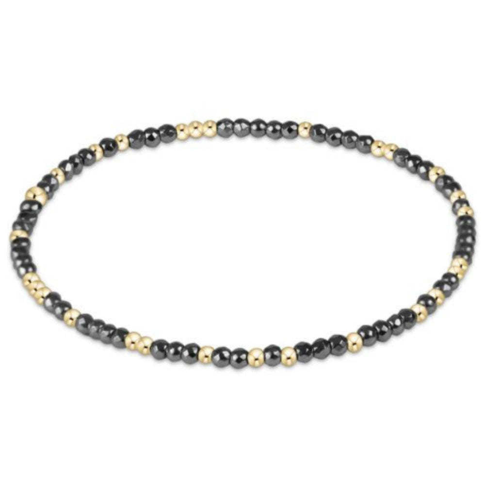 Silver faceted hematite bead bracelet with gold-filled accents on elastic cord
