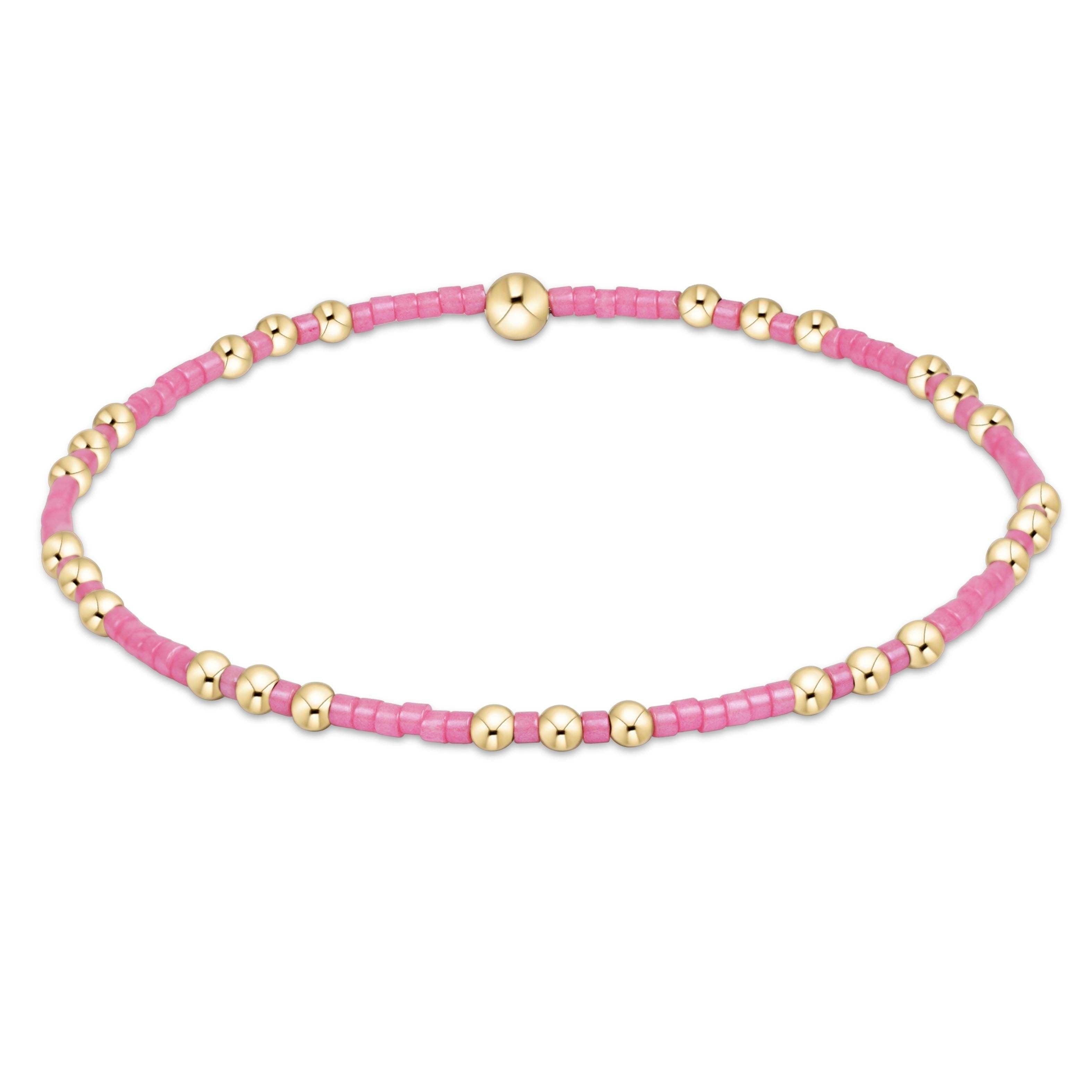 Hope Joy bracelet in bubblegum pink featuring seed beads with gold-filled accents on elastic cord.