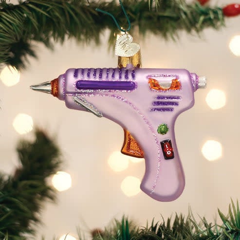 Red hot glue gun ornament with Santa Claus figure holding the tool.