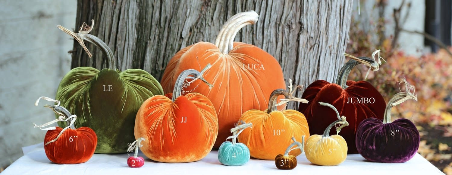 Handmade velvet pumpkin in deep orange with a natural stem.