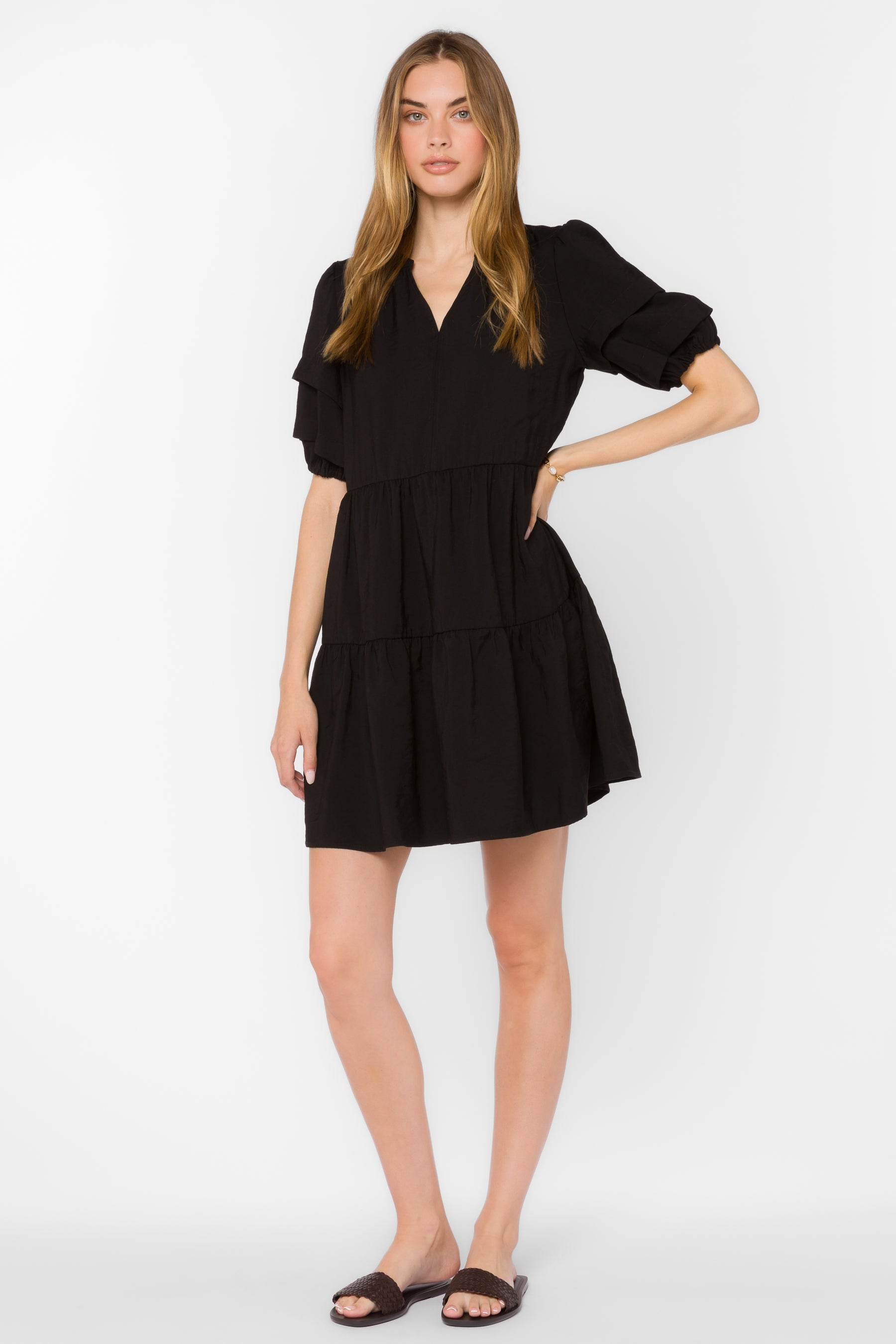 Melita dress in black viscose blend with mandarin collar, pleated puff sleeves, and tiered mini silhouette.