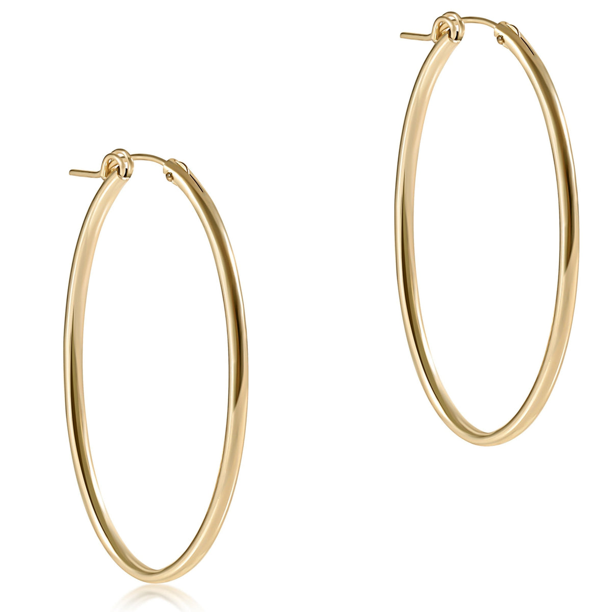 A pair of 2-inch smooth 14kt gold-filled oval hoop earrings against a white background.