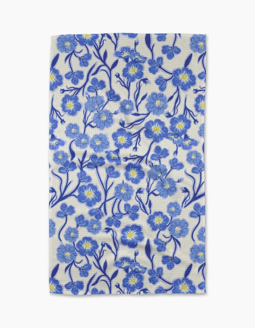 Spring-themed tea towel with waffle weave texture in light blue featuring floral pattern
