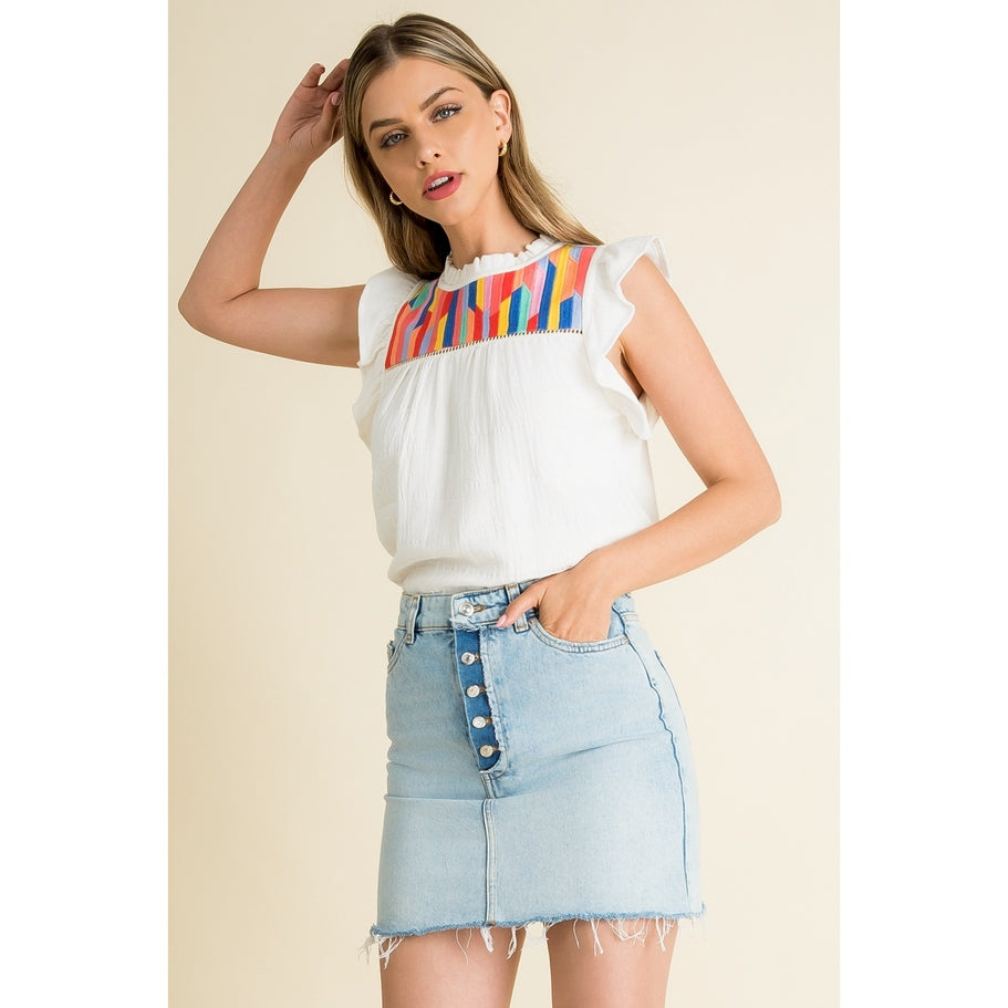 Woven cotton knit top with ruffle sleeves in a light neutral tone featuring subtle embroidery.