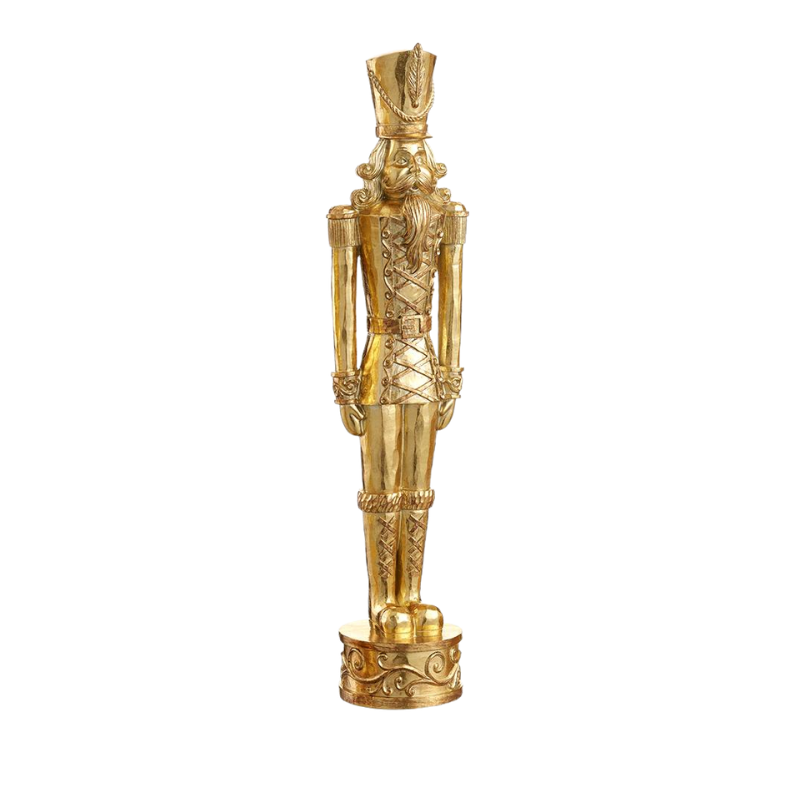 Gold resin nutcracker figurine standing on a decorative base, featuring classic holiday details.