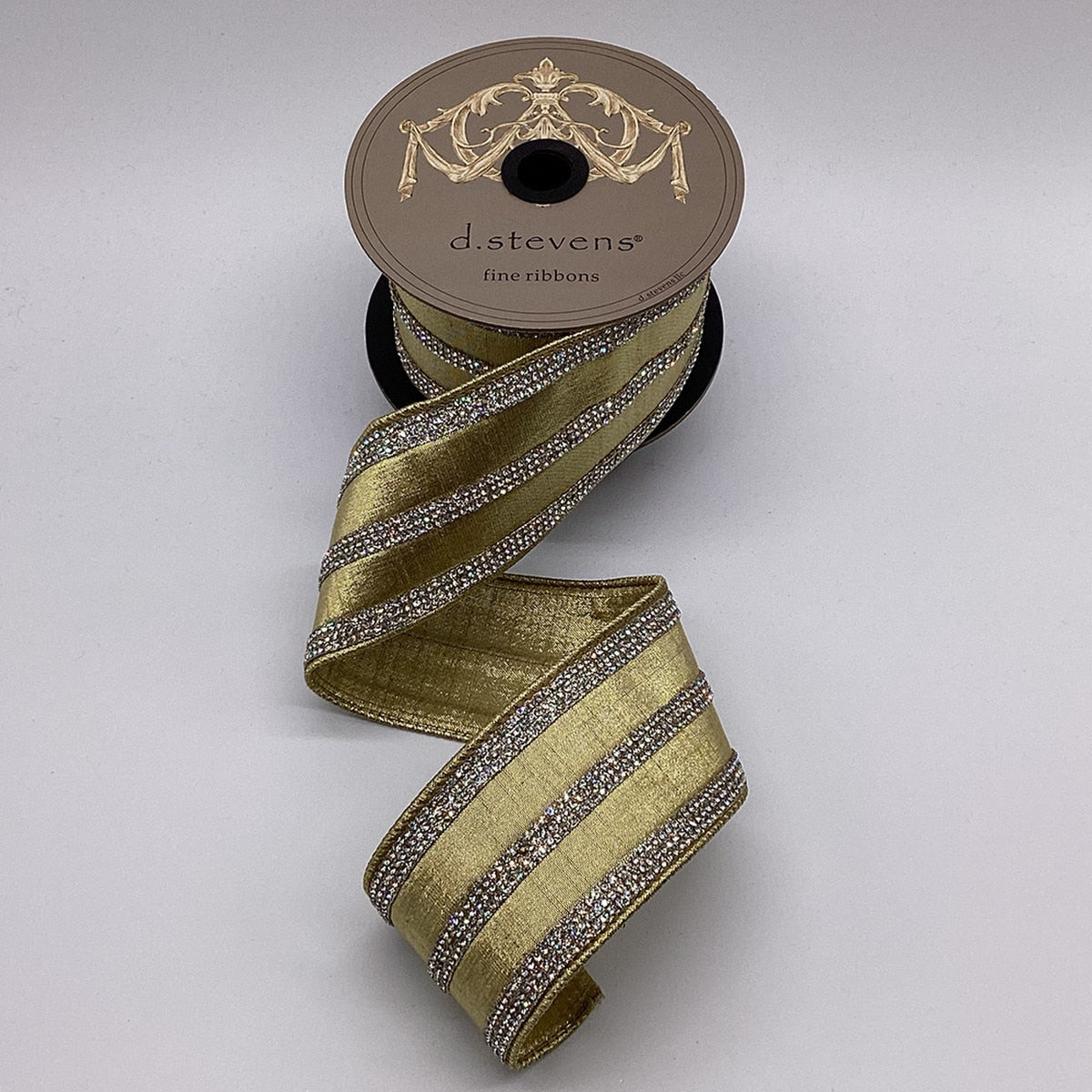 2.5 inch gold metallic dupion ribbon with four rows of clear crystal jewel stripes on a spool.