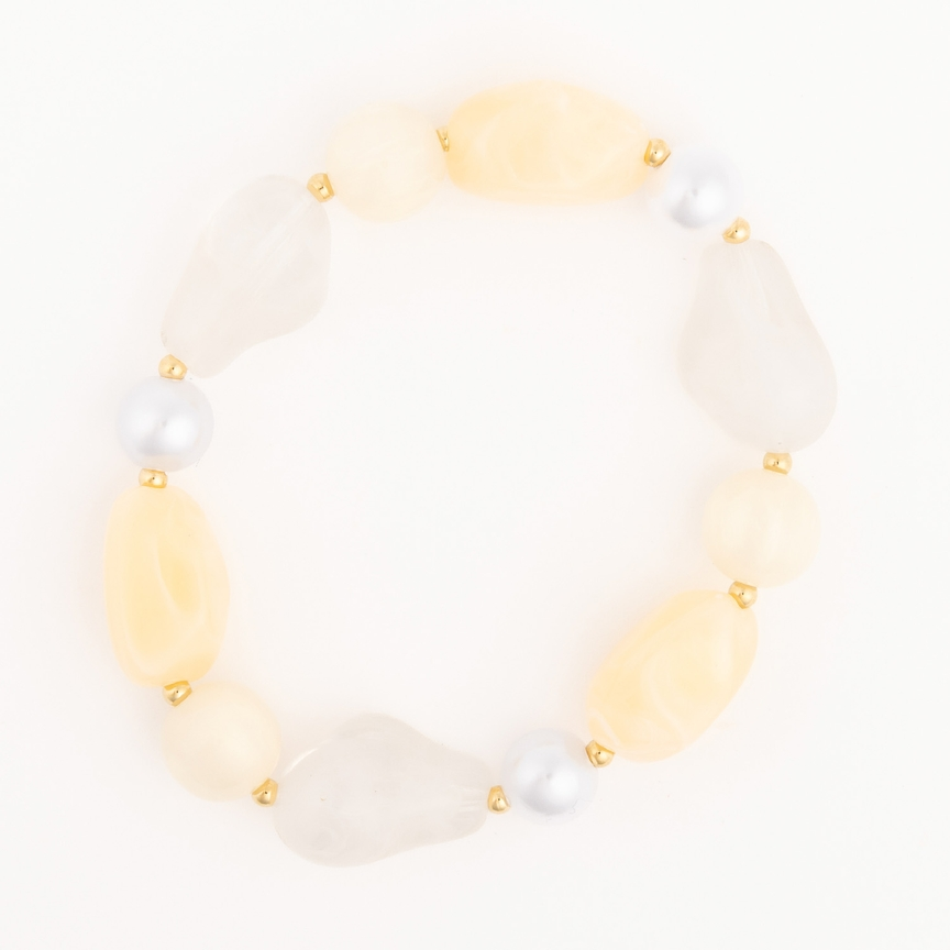 Zoe Bracelet featuring large, irregular pale yellow and white beads with gold-toned spacers.
