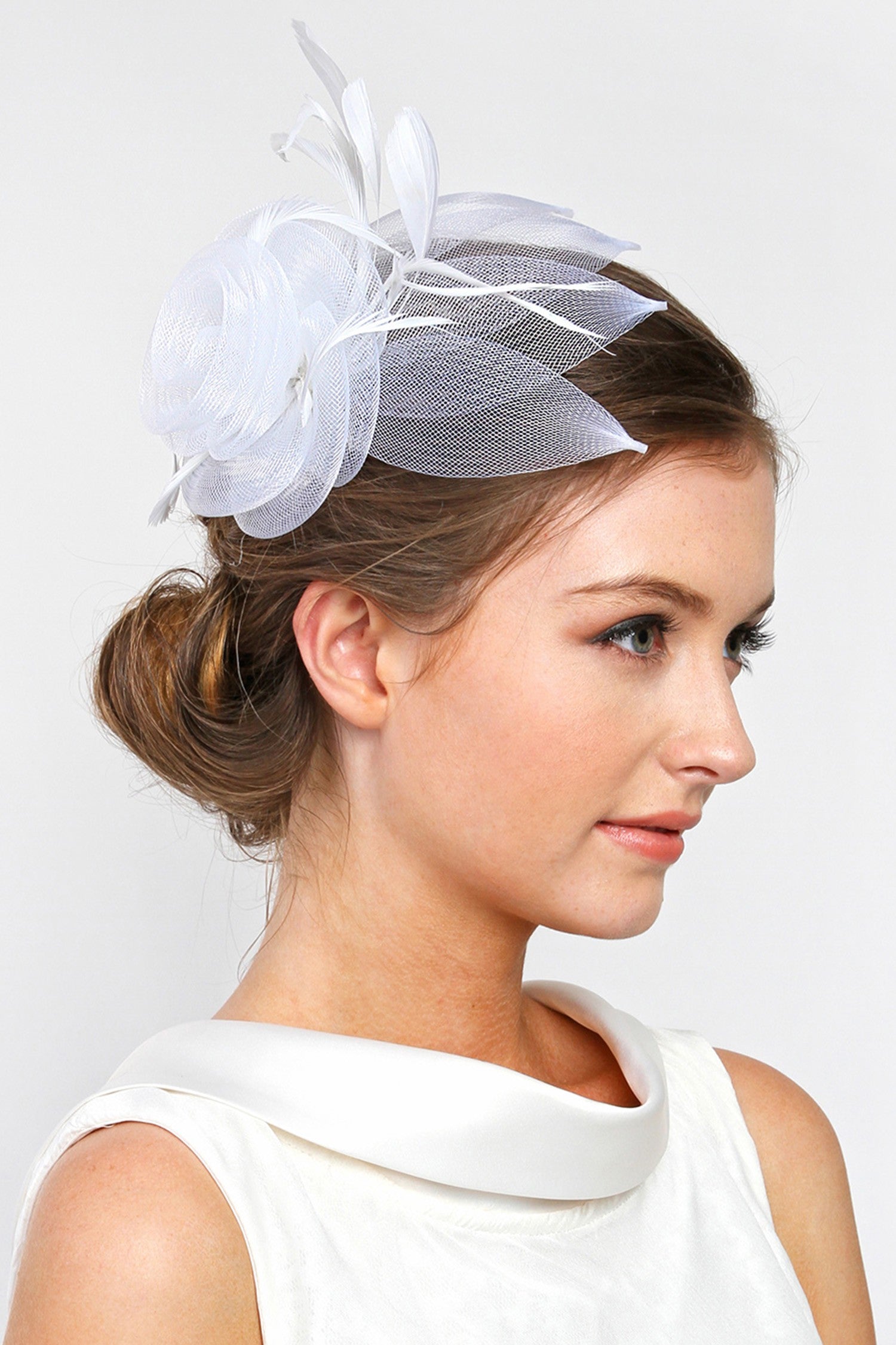 Black mesh fascinator with white floral print featuring a decorative clip.