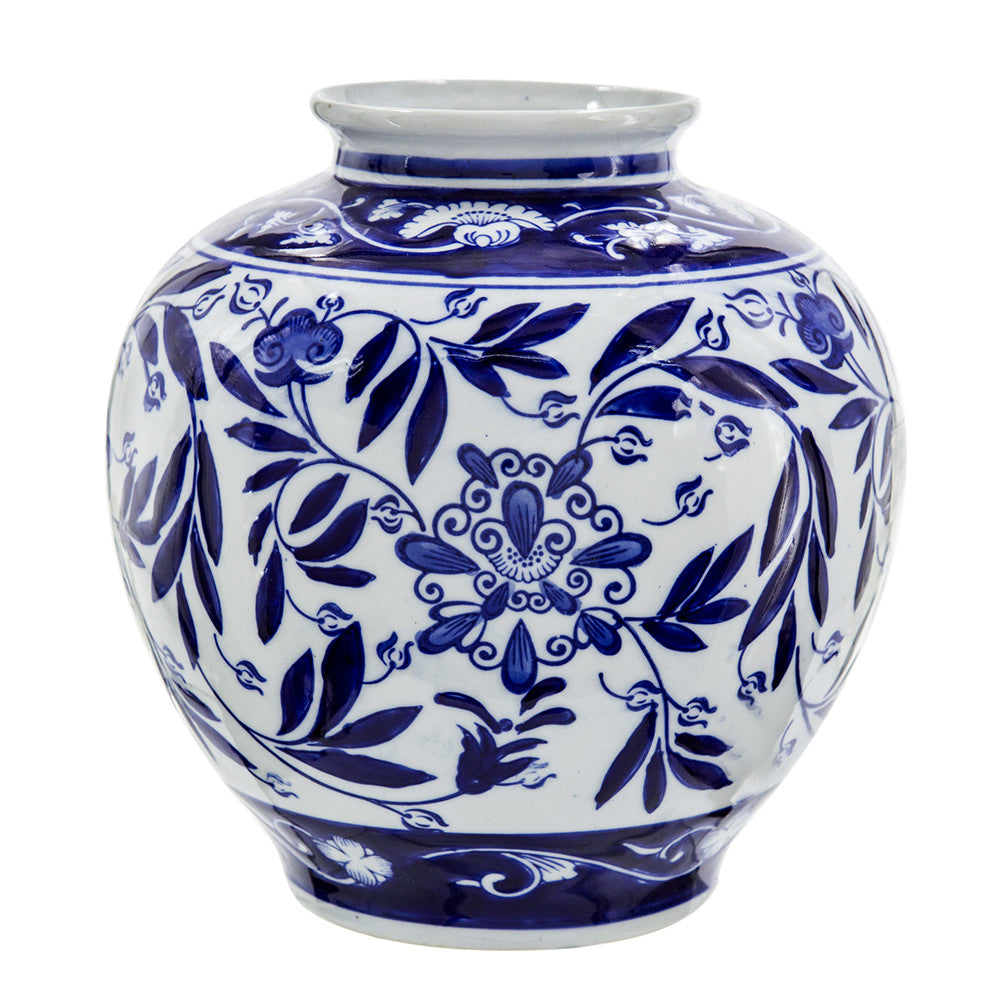 Aline Vase, a round white porcelain jar with blue floral and leaf patterns.