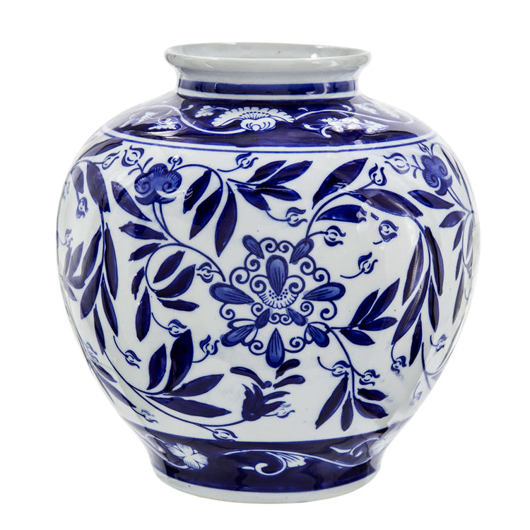 Aline Vase, a round white porcelain jar with blue floral and leaf patterns.