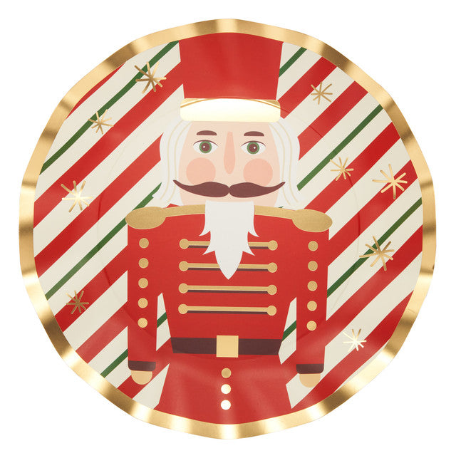 Red paper dinner plate with gold foil trim featuring a wavy nutcracker silhouette and green accents.