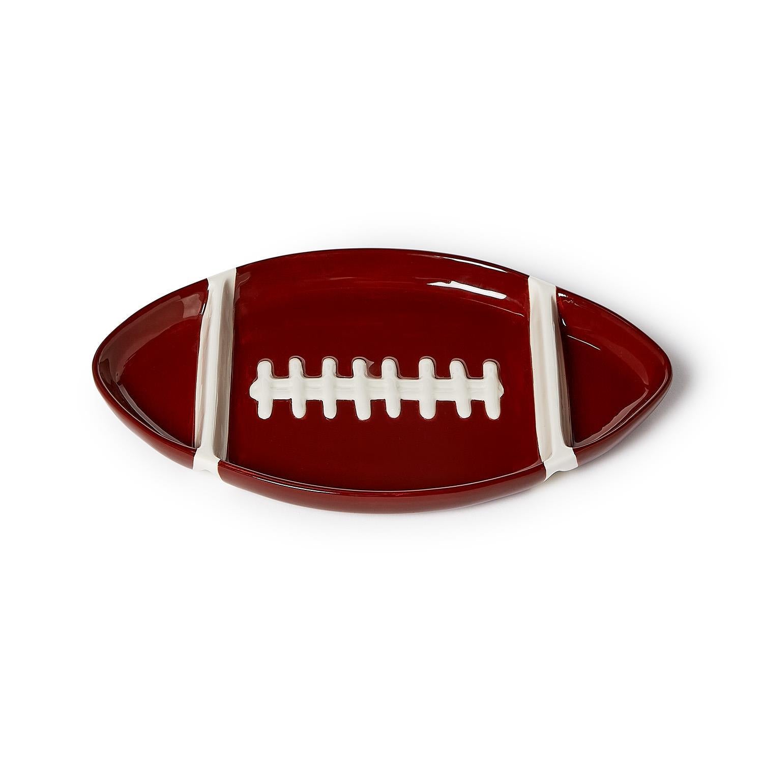 Football-shaped sectional serving platter in dark red dolomite with white laces and stripes.