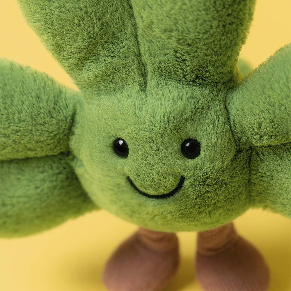 Close-up of Amuseables Siofra Shamrock, a green plush shamrock with a smiling face and brown boots.