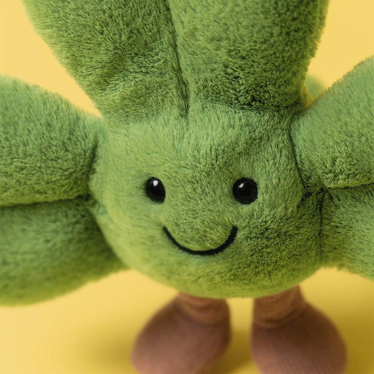 Close-up of Amuseables Siofra Shamrock, a green plush shamrock with a smiling face and brown boots.