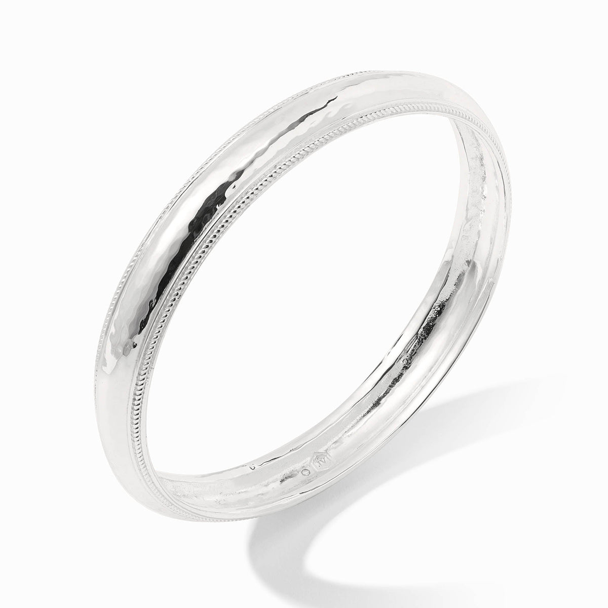 Gold-tone Cannes bangle bracelet with a sleek, polished finish.