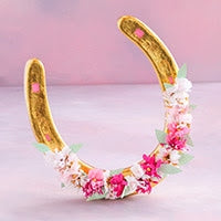 A 4.5-inch gold resin horseshoe ornament decorated with pink and white paper flowers and green leaves.