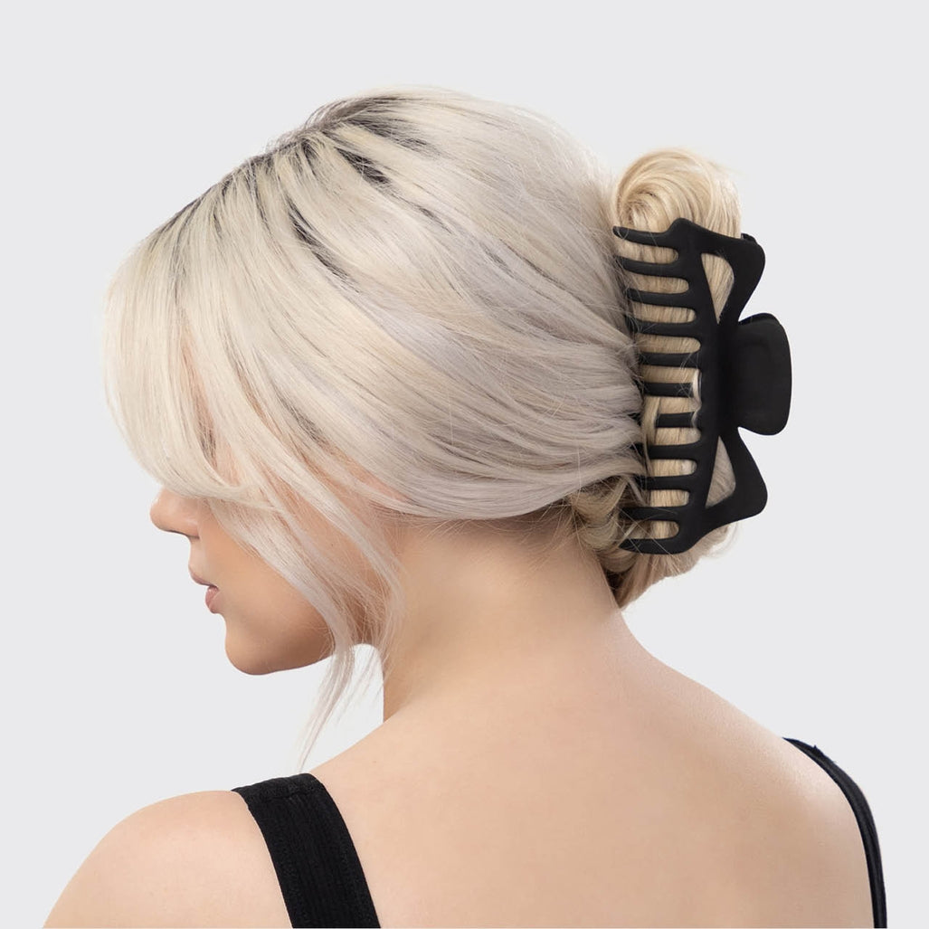 A woman with blonde hair wearing a black Recycled Plastic Jumbo Classic Claw clip.