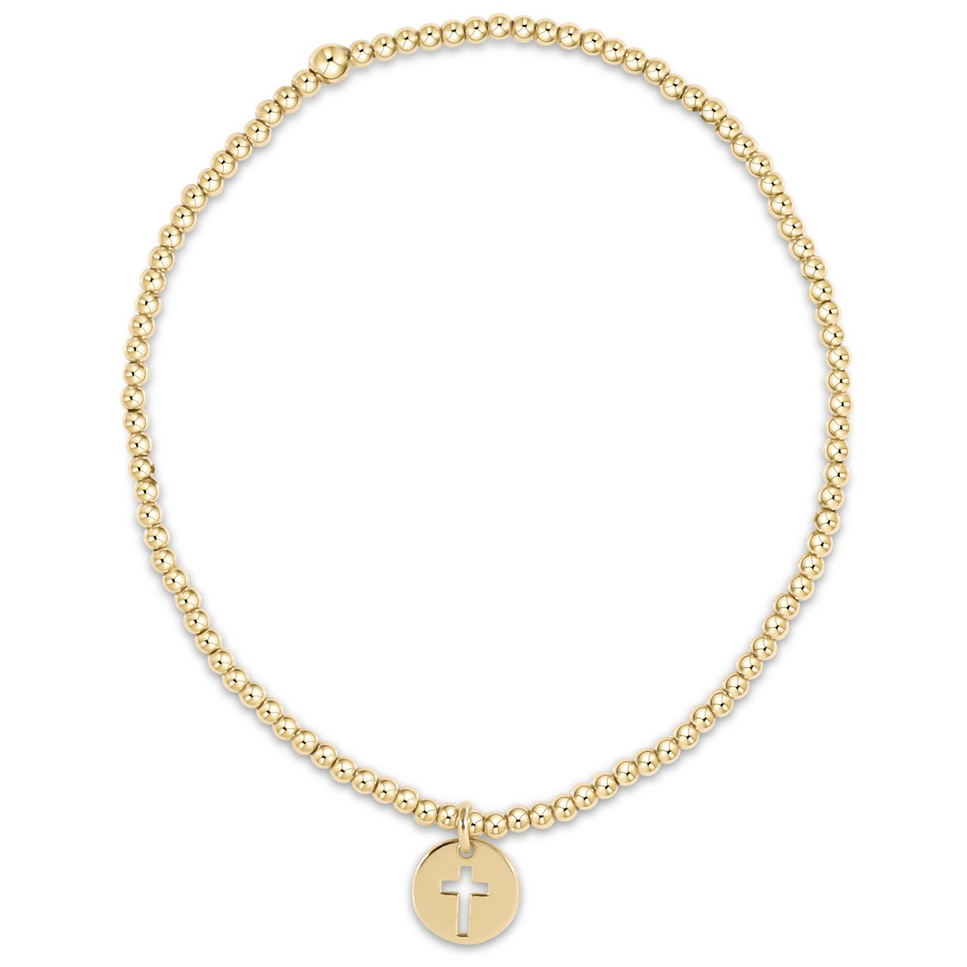 Classic gold 2mm beaded stretch bracelet with a small round disc charm featuring a cross cutout.