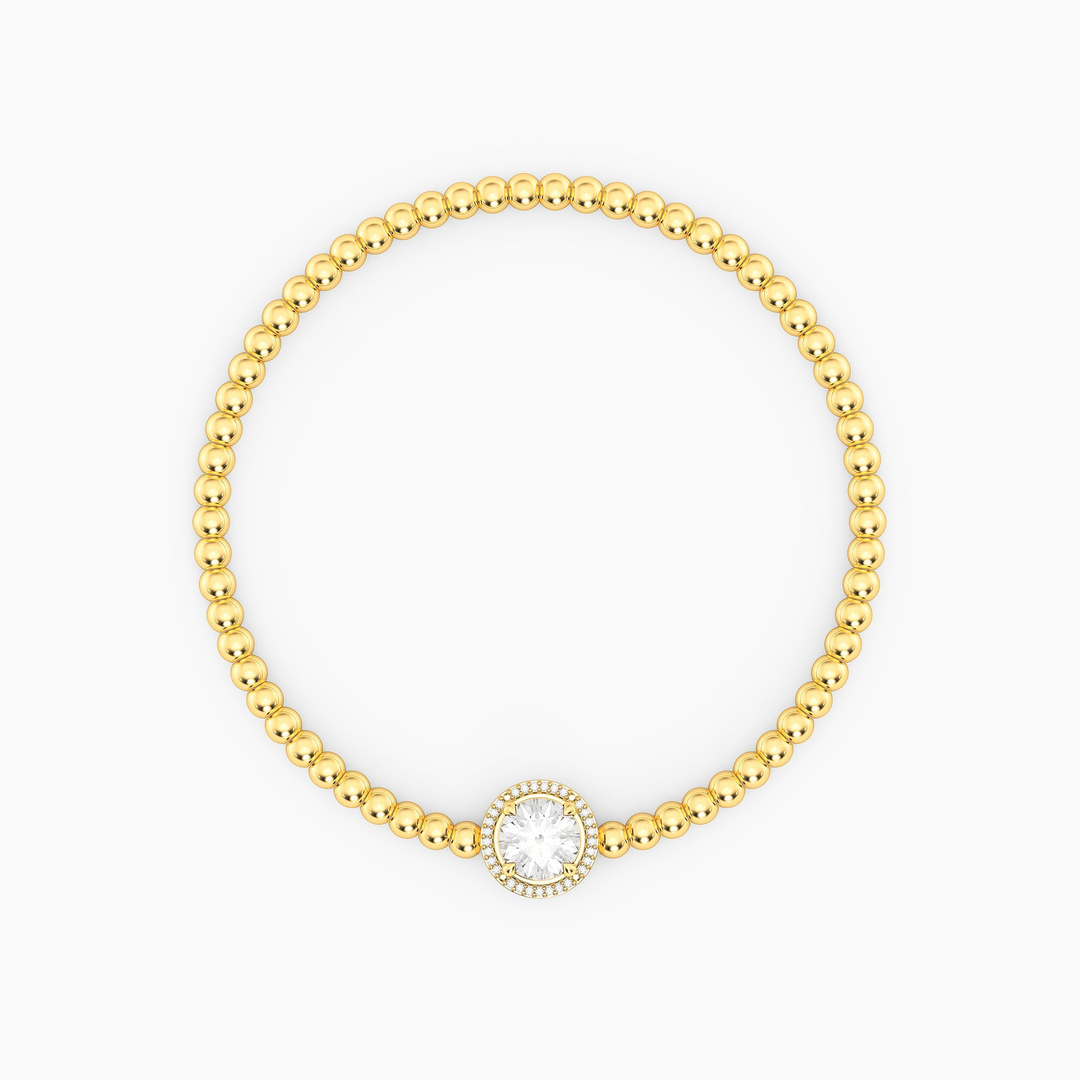Gold-plated beaded bracelet with a round-cut center gemstone and diamond halo.
