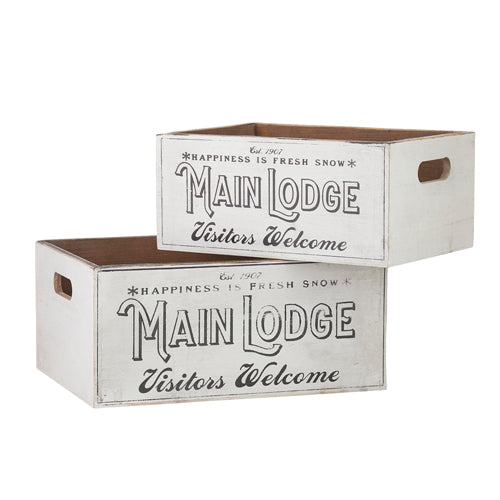 Two white wooden crates with "Main Lodge" and "Visitors Welcome" printed on them.