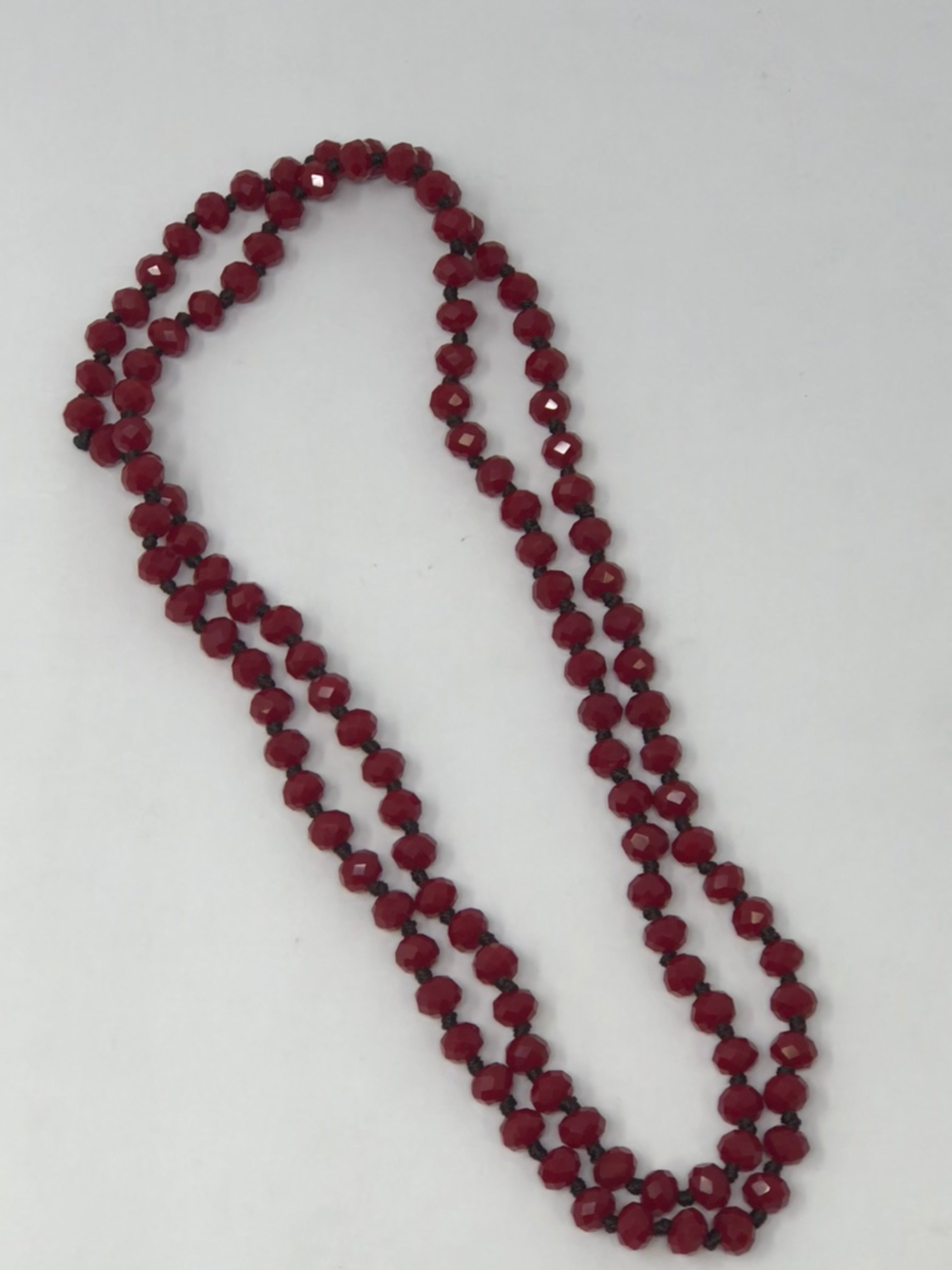 36-inch long dark brown crystal beaded necklace with knotting between beads.