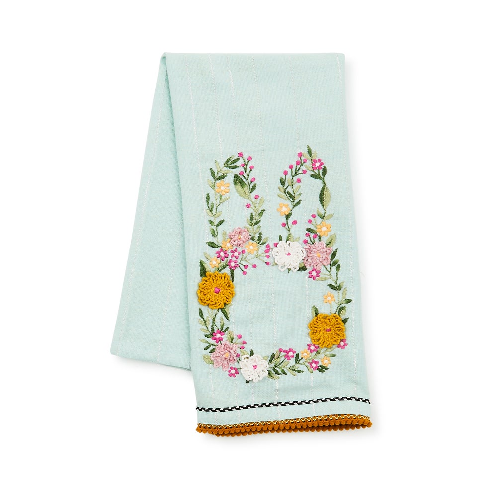 Light blue cotton dish towel featuring an embroidered floral bunny silhouette with pom-pom trim.
