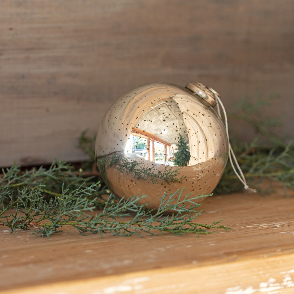 Five-inch round antique silver mercury glass ball ornament with reflective surface
