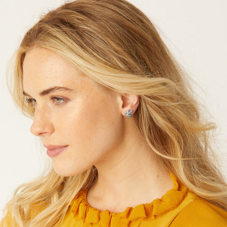 Silver plated mini post earrings featuring a hummingbird silhouette with detailed wings.
