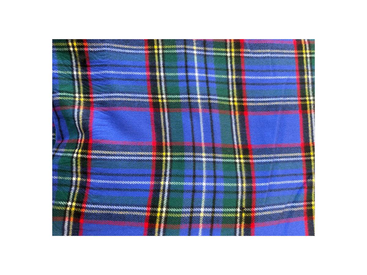 Close-up of a blue Scottish plaid cashmere scarf with green, red, yellow, and white stripes.