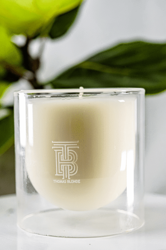 Mod Luxe Candle in a double-walled glass vessel with a neutral-toned wax and wick.