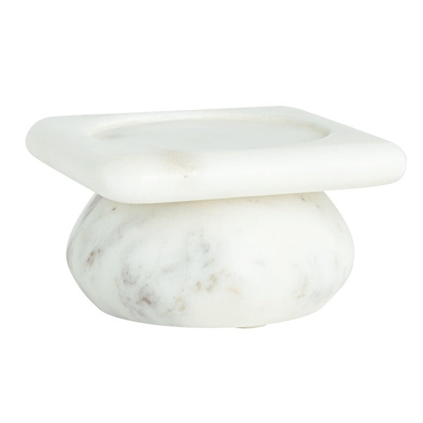 White marble pillar candle holder with a square top and rounded pedestal base.